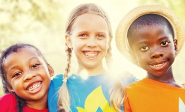 Young children smiling in the sunshine - Family Dentistry at Meadows Dental Group