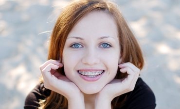 Young teen with braces and a big smile - Orthodontic Treatment at Meadows Dental Group