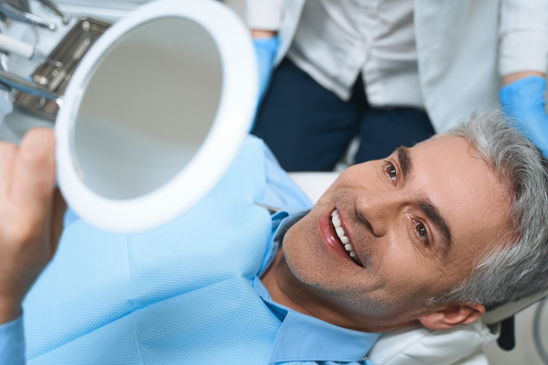 Man after implant treatment for tooth loss